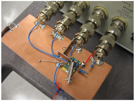 Figure 4. The HP4192A setup showing the board. Excitation through 2 kΩ and voltage readback are on the right. DUT used is LT1792 SO-8 single on postage stamp LB2223. TIA is on the left, internal to HP4192A.