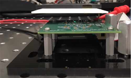 Figure 4. Side view of test setup with tightly controlled air gap between DUT and reflective white card.