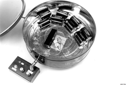 Figure 6b. Shielded can with cover removed. LDO under test occupies center. D-Cells provide power, eliminate potential ground loop. BNC fitting (photo lower left) connects output to filter circuit test box, minimizing triboelectric based errors